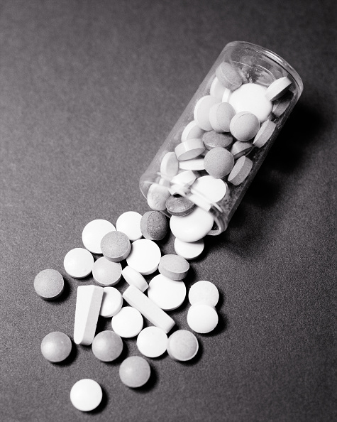 Pills spilling from a glass bottle