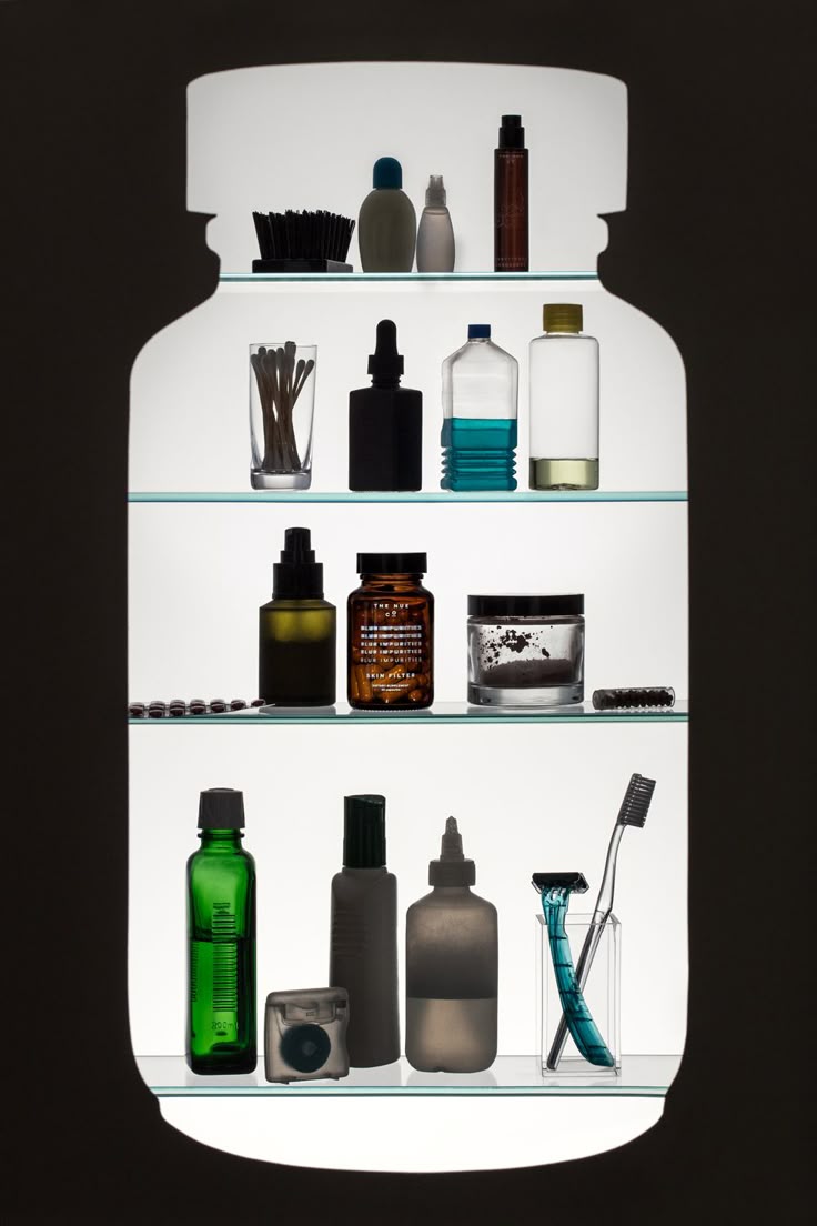 A lit bathroom cabinet of grooming objects